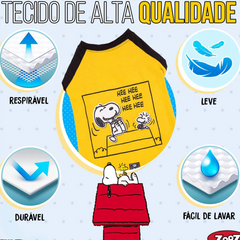 Informação sobre o tecido de uma camisola ZOOZ para cão com design do Snoopy, da cor amarelo, com detalhes pretos. Estampa divertida do personagem a rir. Sobre fundo branco.