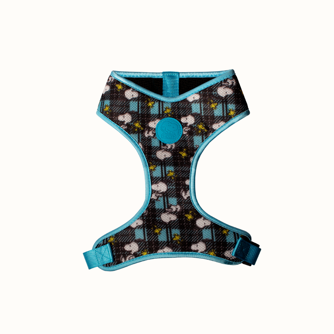 Arnês Corporal Zooz, em padrão azul e preto, com figuras do snoopy e do Woodstock. Vista de frente, sobre fundo branco.