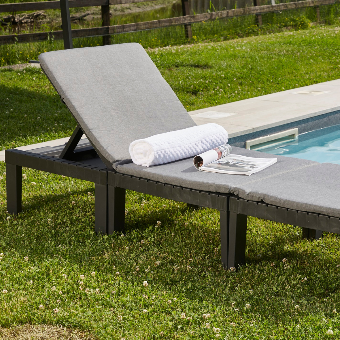 Conjunto IPAE PROGARDEN em plastico de cor cinzenta, composto por três módulos versáteis usado como espreguiçadeira, com almofadas cinzentas no assento e no encosto. Exibido em ambiente exterior.