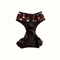 Arnês peitoral Zooz, com o padrão preto e branco, detalhes em vermelho e com figuras do snoopy e forro preto. Vista de frente, sobre fundo branco.
