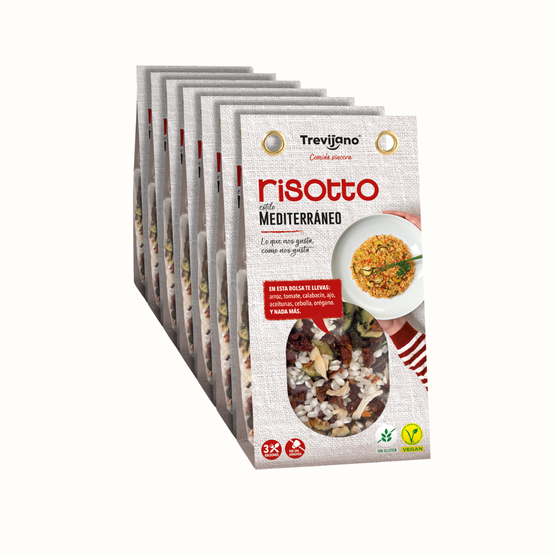 Risotto Mediterraneo em embalagem de cartão e plástico transparente, com uma mistura de vegetais desidratados, ervas aromáticas e especiarias. A embalagem tem um rótulo com o nome do produto e informações nutricionais. Fundo branco.